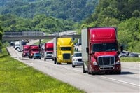Red Semi Leads Traffic On Interstate — Photo