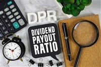 DPR Dividend Payout Ratio text with Calculator, alarm clock and magnifying glass on marble background