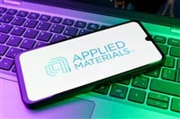 Applied Materials logo on smartphone laying on computer keyboard